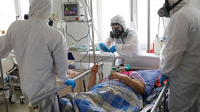Medical staff discuss about treating a patient with coronavirus at an ICU of the Clinical hospital in Volgograd, Russia, Jan. 31, 2022.