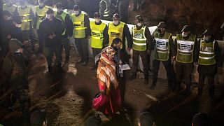 Parents of 5-year-old Rayan walk towards the tunnel as their son's body was being retrieved, in the village of Ighran in Morocco's Chefchaouen province, Feb. 5, 2022