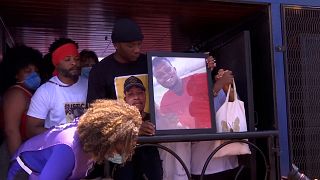 Kabagambe's family in truck holding his picture