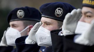 Soldiers of the honor guard wear face masks as they attend a military welcome ceremony by German President Frank-Walter Steinmeier