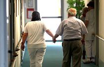 An elderly person is walks with help in a nursing home for elders in Neu Isenburg near Frankfurt, central Germany, June 30, 2009