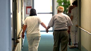 An elderly person is walks with help in a nursing home for elders in Neu Isenburg near Frankfurt, central Germany, June 30, 2009