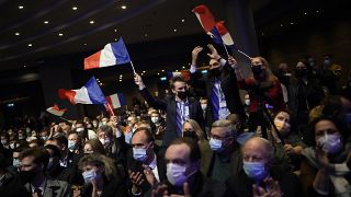 Fans wave French flags as Valerie Pecresse, candidate for the French presidential election 2022, delivers a speech during a meeting in Paris, France on 11 December 2021.