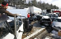 A man looks on crashed cars on the Czech D1 motorway between Prague and Brno where tens of vehicles collided in a series of crashes in a snowstorm on 20 March, 2008