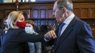 In this handout photo released by Russian Foreign Ministry, British and Russian foreign ministers Liz Truss and Sergei Lavrov greet each other in Moscow, Feb. 10, 2022.