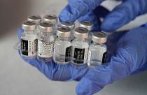 A medical worker shows vials of the Pfizer COVID-19 vaccine near Jakarta, Indonesia.