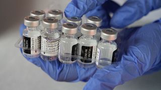 A medical worker shows vials of the Pfizer COVID-19 vaccine near Jakarta, Indonesia.