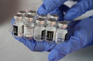 A medical worker shows vials of the Pfizer COVID-19 vaccine near Jakarta, Indonesia.