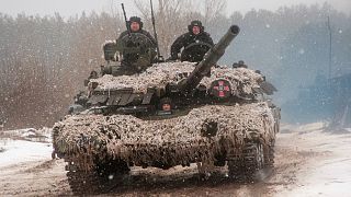 A Ukrainian tank moves during military drills close to Kharkiv, Ukraine, Thursday, Feb. 10, 2022.