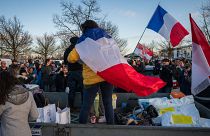 Participants of the so-called "Freedom Convoy" wave French flags as they gather before leaving Strasbourg for Paris on Friday.