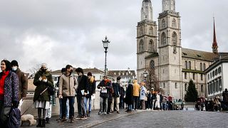 People queue from the Muenster Bridge to vote in a COVID-19 referendum, in Zurich, Switzerland, in this file photograph from Nov. 28, 2021.