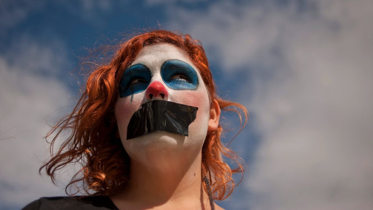 A gagged gay activist from the platform "We are not crime" looks on as she protests against the public security law "Ley Mordaza"