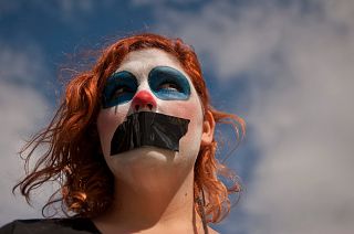 A gagged gay activist from the platform "We are not crime" looks on as she protests against the public security law "Ley Mordaza"