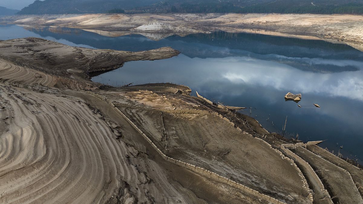 The roof of an old house, submerged three decades ago when a hydropower dam flooded the valley, is photographed emerged due to drought at the Lindoso reservoir, in northwester