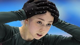 Kamila Valieva, of the Russian Olympic Committee, puts her hands on her head during a training session at the 2022 Winter Olympics