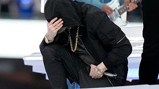 Eminem kneels down during the halftime performance at the NFL Super Bowl 56 football game between the Los Angeles Rams and the Cincinnati Bengals, Feb. 13, 2022.