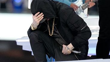 Eminem kneels down during the halftime performance at the NFL Super Bowl 56 football game between the Los Angeles Rams and the Cincinnati Bengals, Feb. 13, 2022.