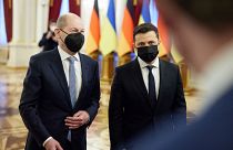 This handout picture taken and released by the Ukrainian presidential press-service shows President Volodymyr Zelensky (R) welcoming German Chancellor Olaf Scholz