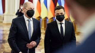This handout picture taken and released by the Ukrainian presidential press-service shows President Volodymyr Zelensky (R) welcoming German Chancellor Olaf Scholz