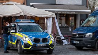 Police vehicles are stand in front of a restaurant in the city of Weiden, Germany, Feb. 13, 2022.