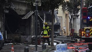 Rescue teams walks near to debris and burned houses after an explosion in Saint-Laurent-de-la-Salanque