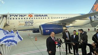 Israeli Prime Minister Naftali Bennett speaks to reporters on the tarmac at Ben Gurion Airport before departing for an official visit to Bahrain, in Lod, Israel.