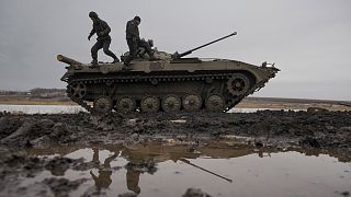 Ukrainian servicemen walk on an armored fighting vehicle during an exercise in a Joint Forces Operation controlled area in the Donetsk region, eastern Ukraine.