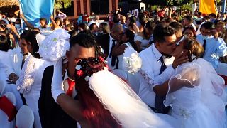 Newly married couples kiss on Valentine's Day in Managua, Nicaragua.