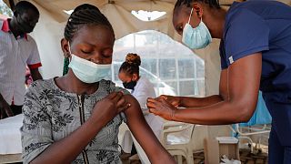 A nurse administers an AstraZeneca vaccine against COVID-19 at a district health centre in the low-income Kibera neighbourhood of Nairobi, Kenya, Jan. 20, 2022.