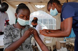 A nurse administers an AstraZeneca vaccine against COVID-19 at a district health centre in the low-income Kibera neighbourhood of Nairobi, Kenya, Jan. 20, 2022.