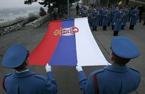A Serbian army guard of honour raises a Serbian flag, on the eve of Serbian Statehood Day 2008, in Belgrade,