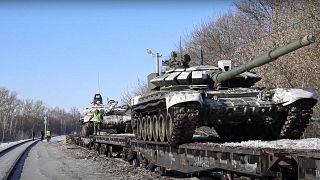 In this photo taken from video provided by the Russian Defense Ministry on Wednesday, 16 February, Russian army tanks are loaded onto railway platforms.