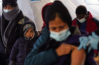 A migrant receives a booster Johnson and Johnson vaccine against COVID-19 at Karatepe refugee camp, on the northeastern Aegean island of Lesbos, Greece, Wednesday, Dec. 15, 20