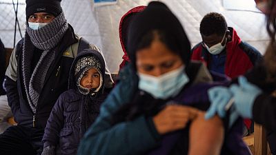 A migrant receives a booster Johnson and Johnson vaccine against COVID-19 at Karatepe refugee camp, on the northeastern Aegean island of Lesbos, Greece, Wednesday, Dec. 15, 20