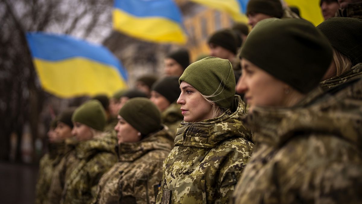 Ukrainian Army soldiers pose for a photo as they gather to celebrate a Day of Unity in Odessa, Ukraine, Wednesday, Feb. 16, 2022. 