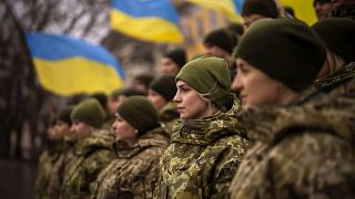 Ukrainian Army soldiers pose for a photo as they gather to celebrate a Day of Unity in Odessa, Ukraine, Wednesday, Feb. 16, 2022.