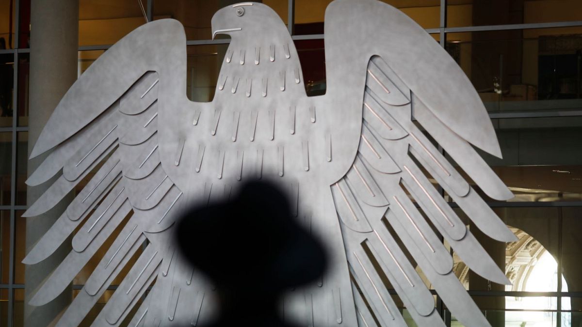 A Rabbi sits in front of Germany's heraldic Eagel as he attends a special meeting of the German Parliament.