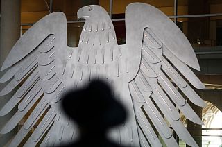 A Rabbi sits in front of Germany's heraldic Eagel as he attends a special meeting of the German Parliament.