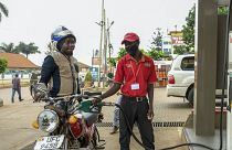 An attendant fuels a motorcycle at a Total gas station in the Kamwokya suburb of Kampala, Uganda Tuesday, Feb. 1, 2022.