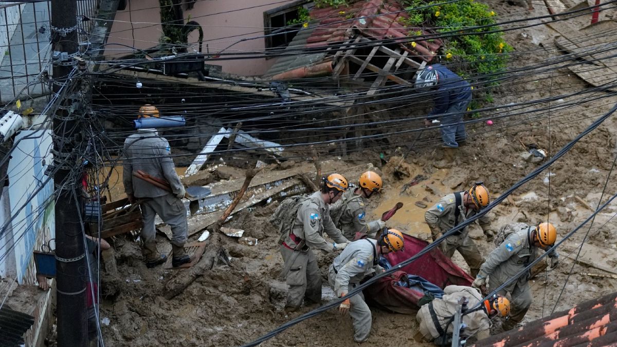 Rescue workers carry the body of a landslide victim in Petropolis, Brazil, Feb. 16, 2022. 