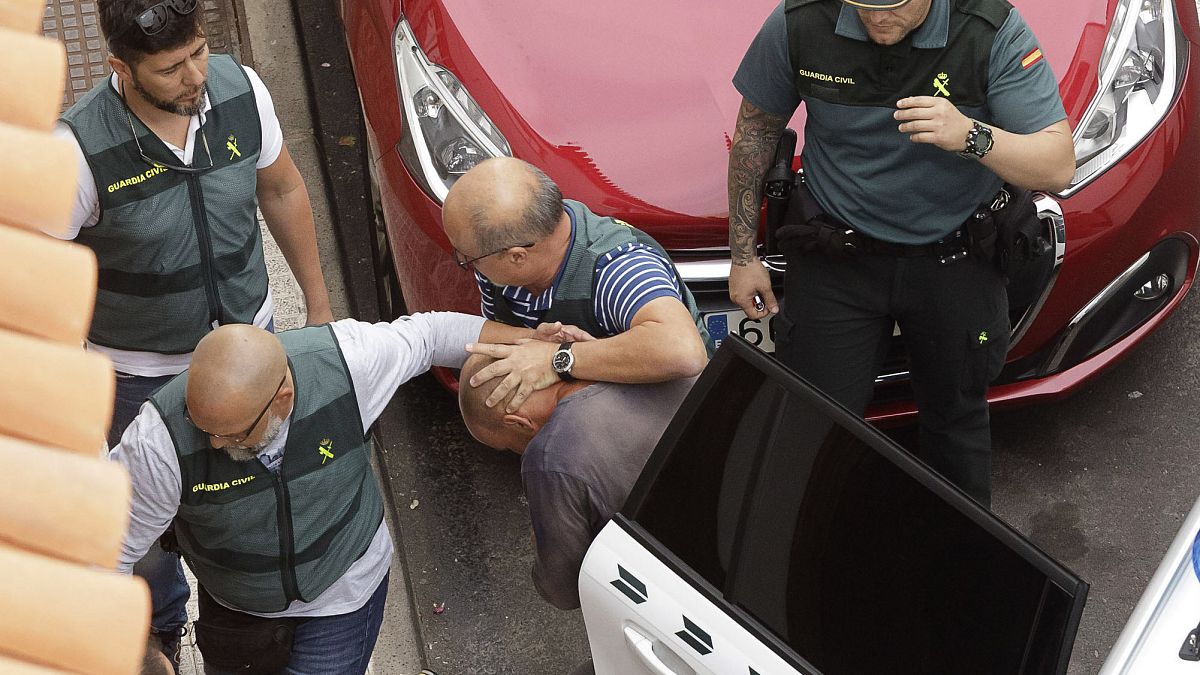 Members of the Spain's Civil Guard lead the suspect away after his arrest in April 2019.