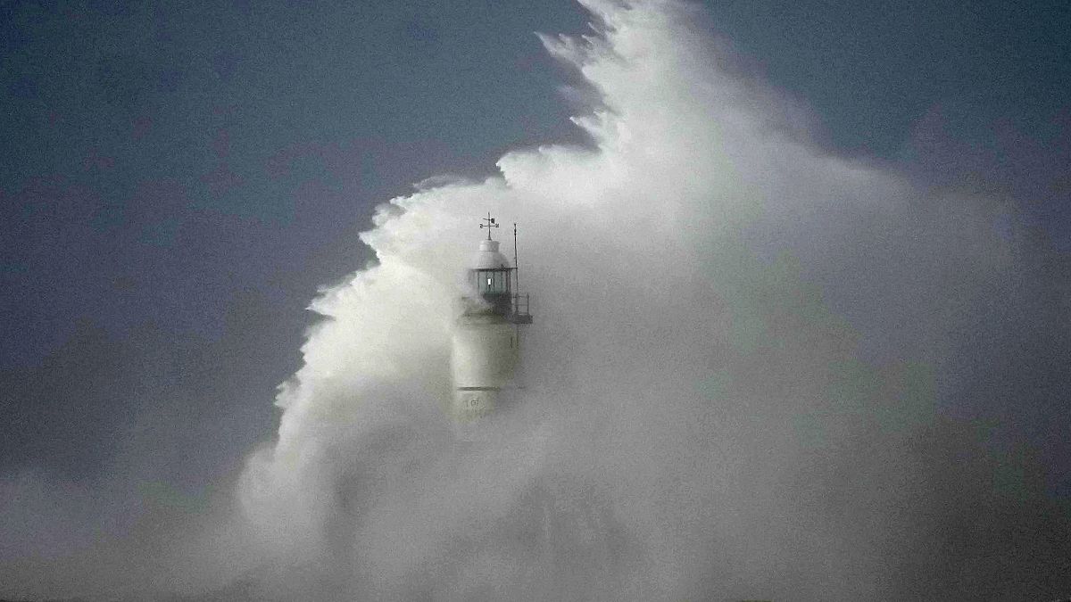 Waves crash over the Newhaven harbour breakwater and lighthouse, as Storm Eunice hits Newhaven, on the south coast of England, Friday, Feb. 18, 2022