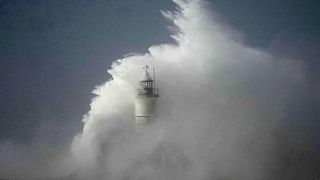 Waves crash over the Newhaven harbour breakwater and lighthouse, as Storm Eunice hits Newhaven, on the south coast of England, Friday, Feb. 18, 2022