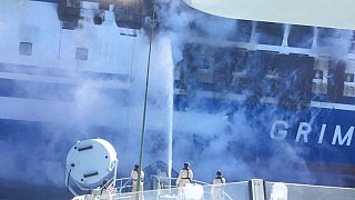 Firefighters hoses down the burning Euroferry Olympia with 291 people on board near the Greek island of Corfu, Friday, Feb. 18, 2022.