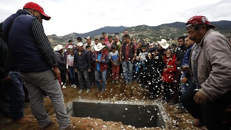 Family and friends grieve around the grave of anti-logging activist Homero Gomez Gonzalez in Ocampo, Michoacan state, Mexico.