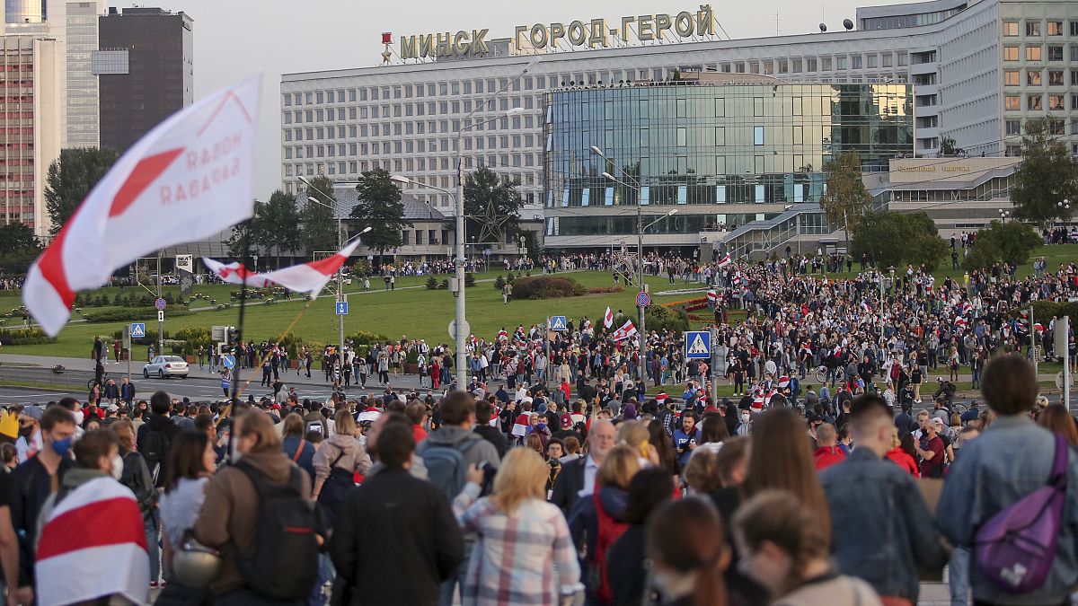 People with old Belarusian national flags gather during an opposition rally in Minsk in September 2020.