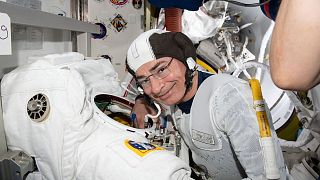 Astronaut and Expedition 65 Flight Engineer Mark Vande Hei inspects a spacesuit in preparation for a spacewalk at the International Space Station in August 2021.