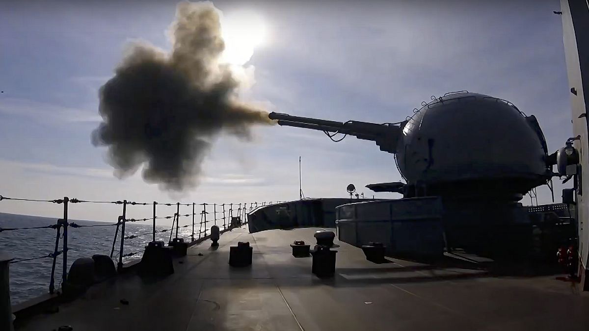 on Friday, Feb. 18, 2022, A cannon mounted on a Russian warship fires during a naval exercise in the Black Sea. 