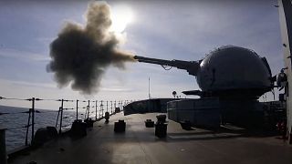 on Friday, Feb. 18, 2022, A cannon mounted on a Russian warship fires during a naval exercise in the Black Sea.