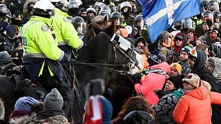 Police take action to put an end to a protest, which started over mandatory COVID vaccine mandates and grew into a wider anti-government demonstration, Feb. 18, 2022, Ottawa.